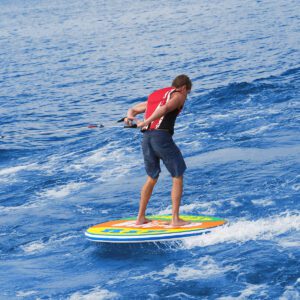 Man balancing on colorful paddleboard