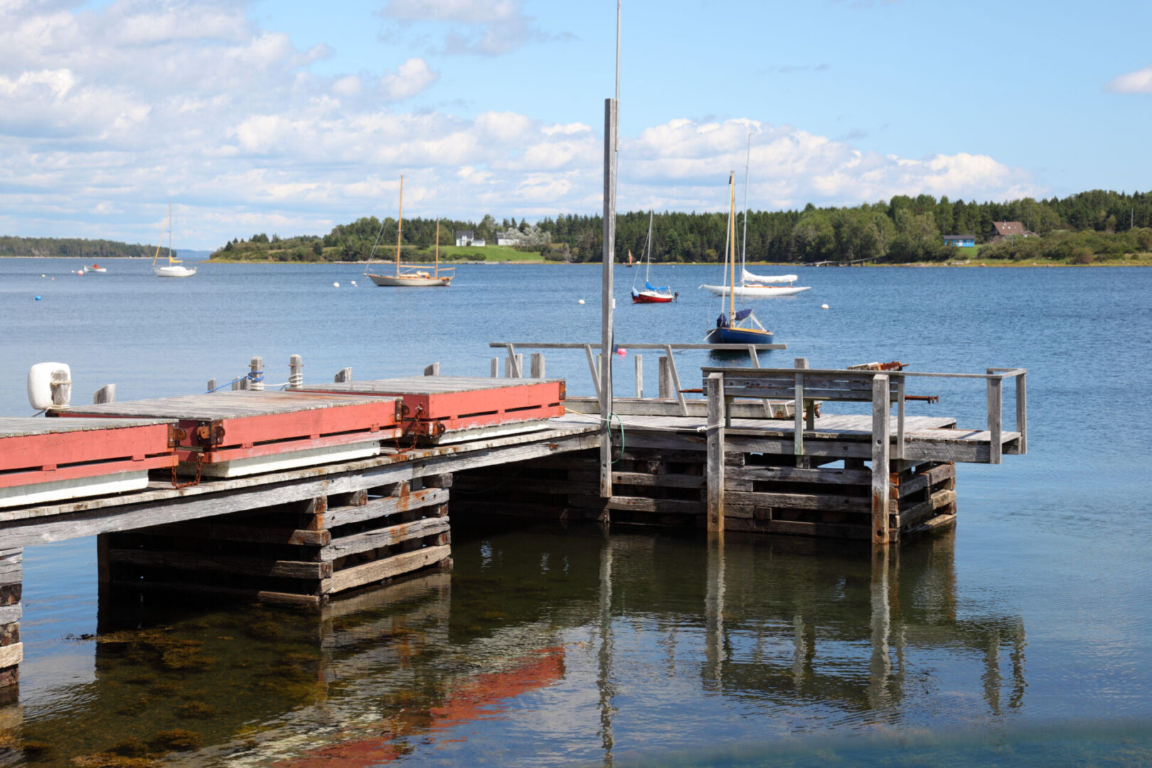 Boats anchored near wooden pier