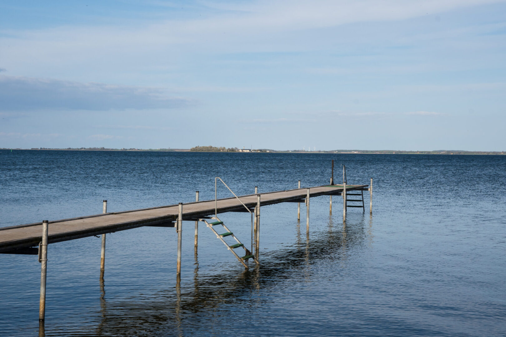 Wooden pier over calm blue water